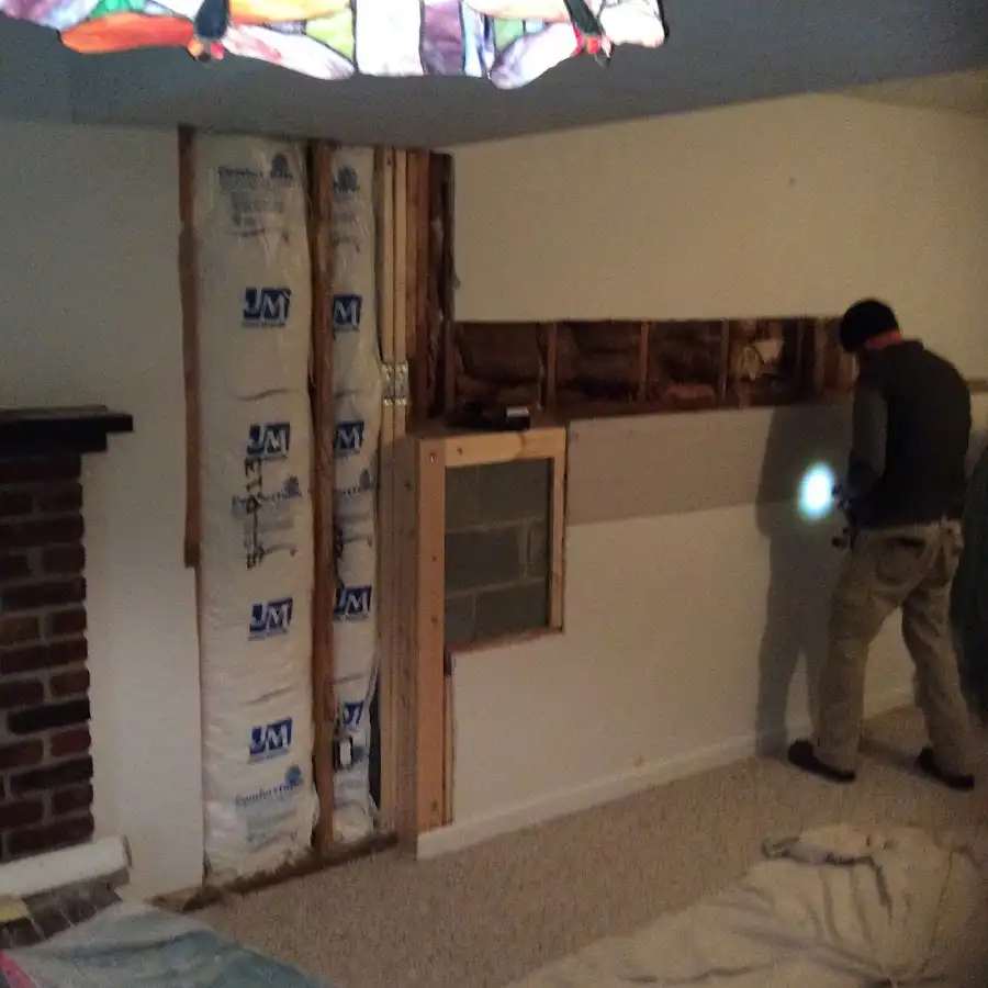 Restoration technician inspecting water damage in Whitefish Bay
